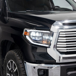 Side view of a black Toyota Tundra truck with LED reflector headlights and form lights