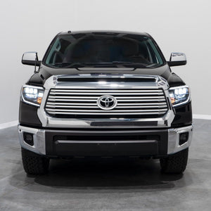 Front view of a black Toyota Tundra truck with LED reflector headlights and form lights