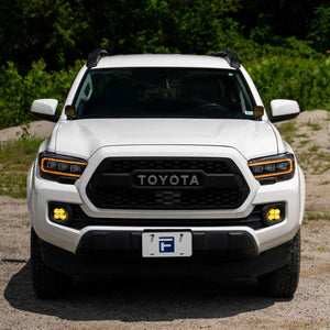 White Toyota Tacoma front end view with Form Lights Sequential LED Projector Headlights (Amber DRL) for Toyota Tacoma