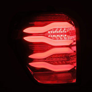 AlphaRex PRO-Series LED Tail Lights (Jet Black) for Toyota 4Runner in a red light