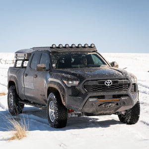The Toyota Tacoma truck parked in a snowy landscape